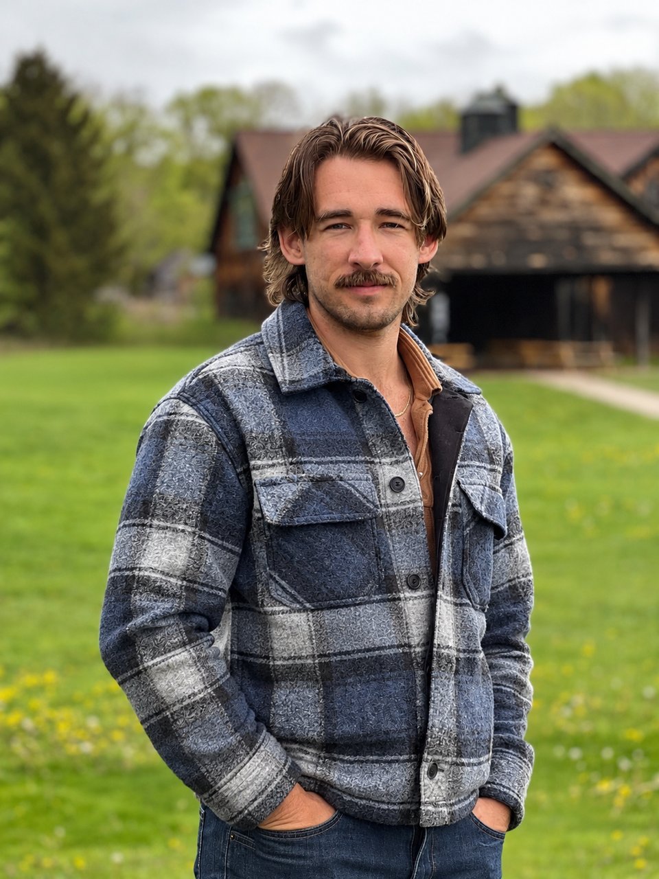 David Glinski outdoors, wearing a blue-gray plaid jacket.