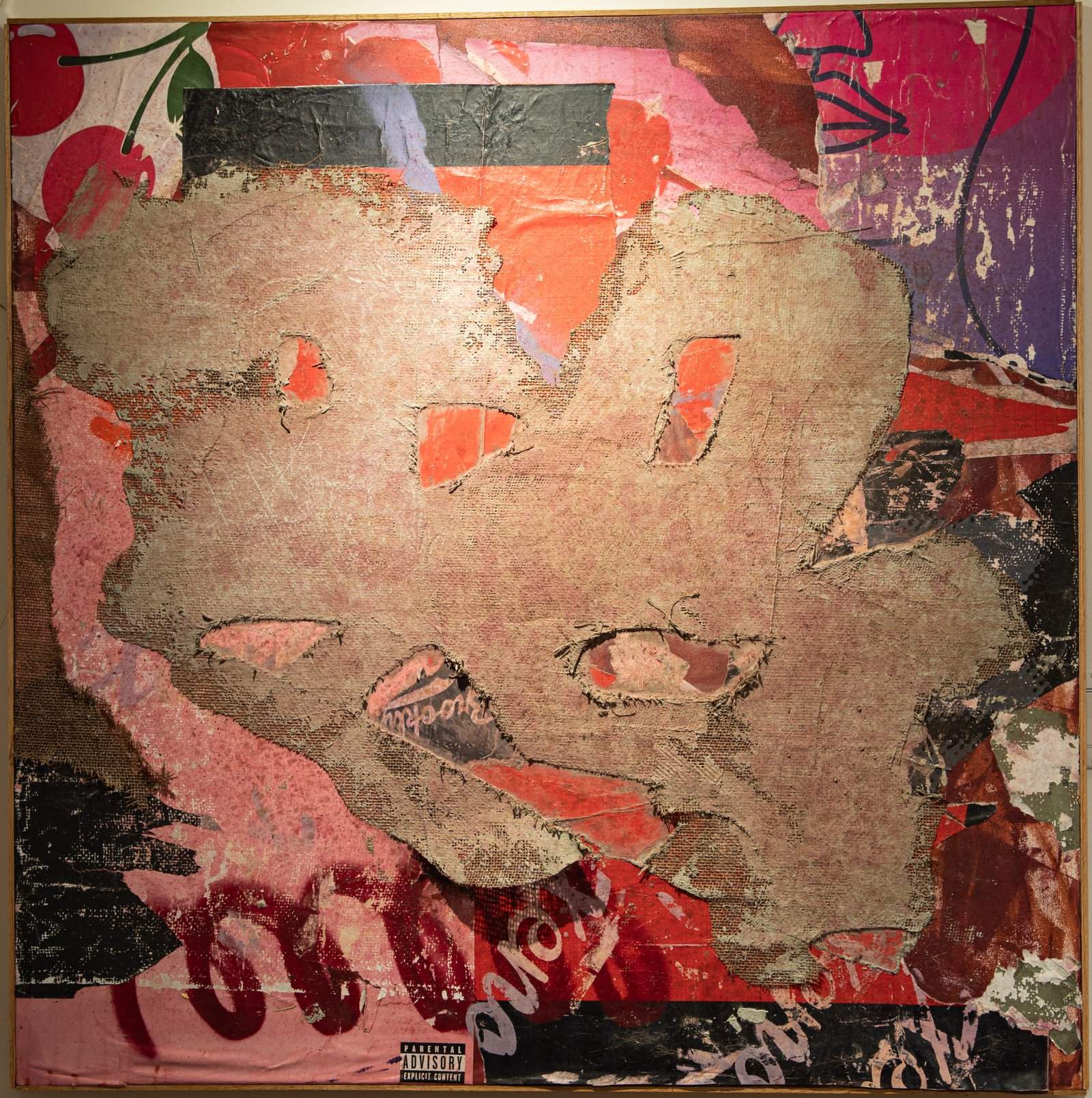 Pale burlap forms with torn openings over layers of pink, red, purple and printed paper.